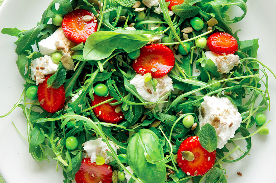 Salad with marinated strawberries and goat ricotta.