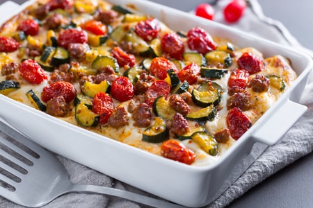 Lasagna with courgettes, confit tomatoes and sausage