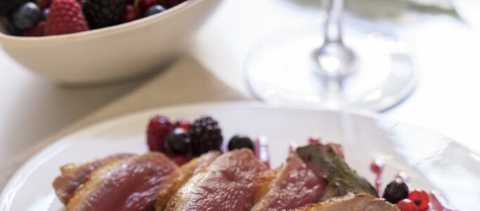 Duck breast with red wine sauce and berries