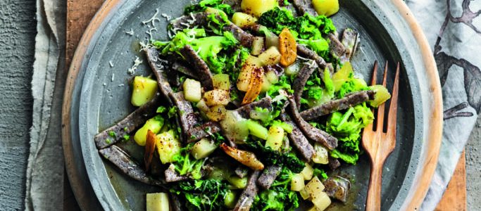 Traditional pizzoccheri with cabbage, garlic and casera