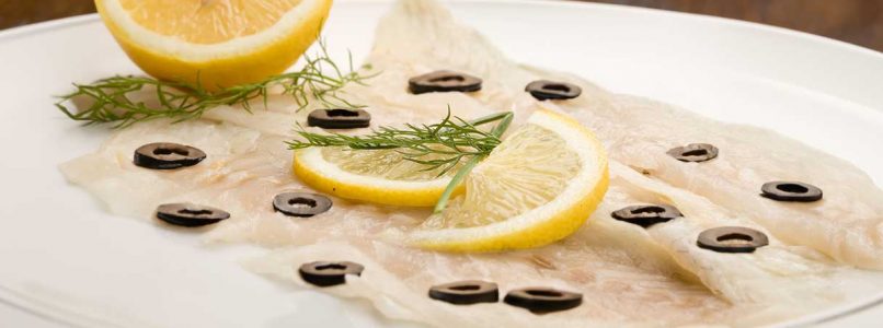 cod carpaccio with citrus fruits and black olives, for a refined appetizer